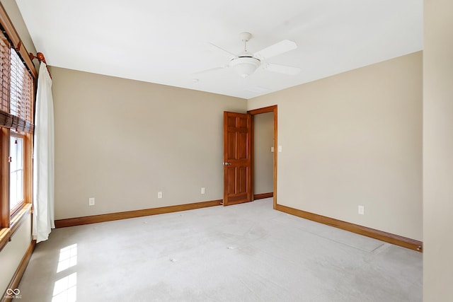 carpeted empty room featuring ceiling fan