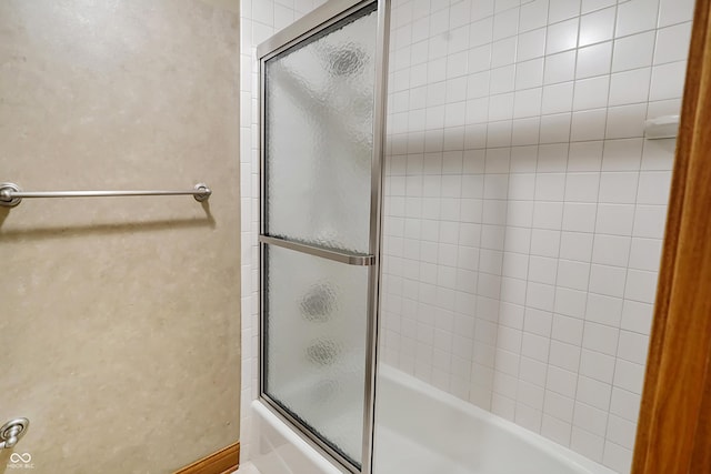 bathroom featuring shower / bath combination with glass door