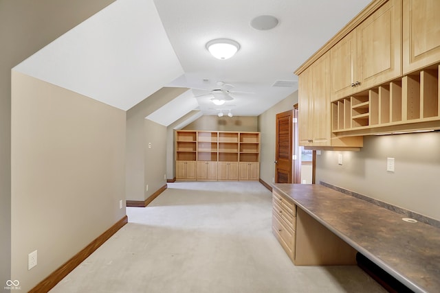 interior space featuring light carpet, vaulted ceiling, and ceiling fan