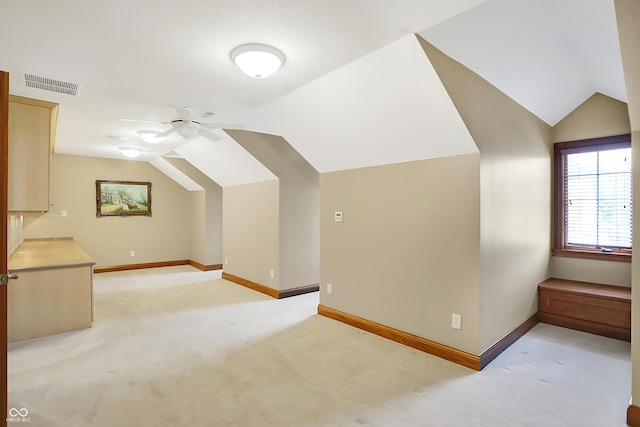 bonus room with light carpet, ceiling fan, and vaulted ceiling