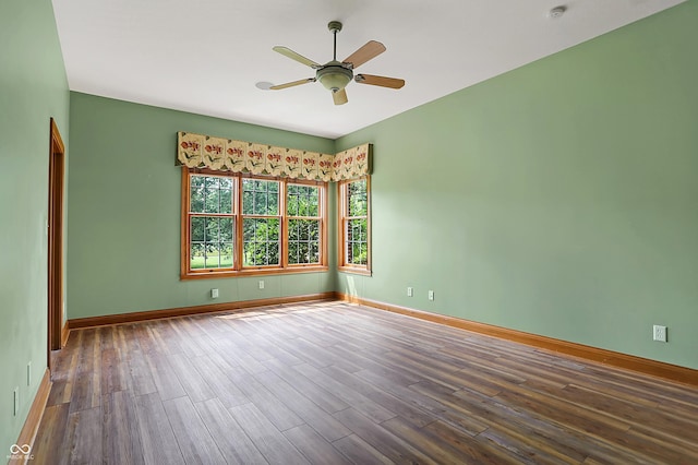 empty room featuring ceiling fan and dark wood-type flooring