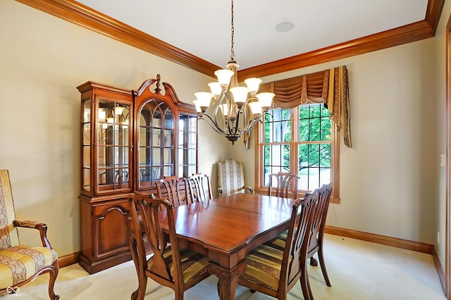 dining room with light carpet, ornamental molding, and a notable chandelier