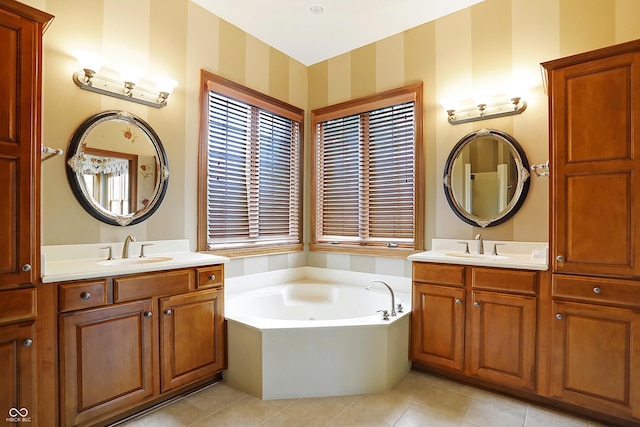 bathroom with tile patterned floors, vanity, and a tub to relax in