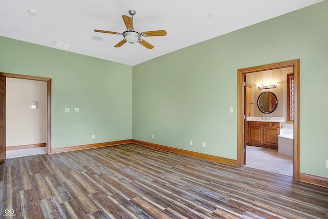 unfurnished room featuring ceiling fan, light hardwood / wood-style floors, and sink