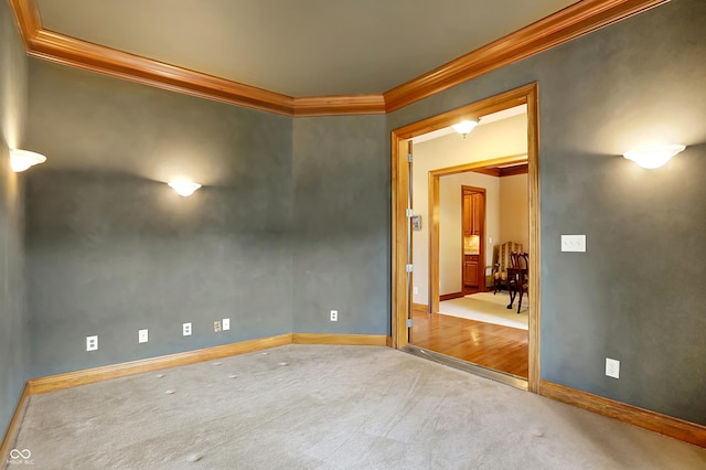 carpeted empty room featuring ornamental molding