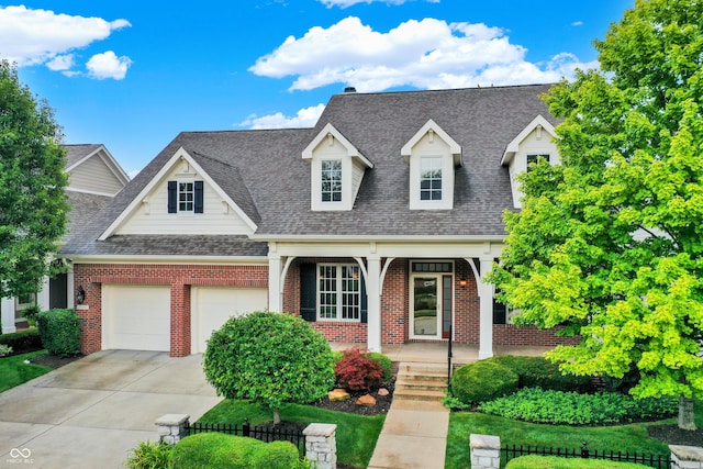 view of front of house with covered porch and a garage