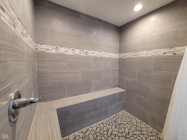 bathroom with tile walls and a shower with shower curtain