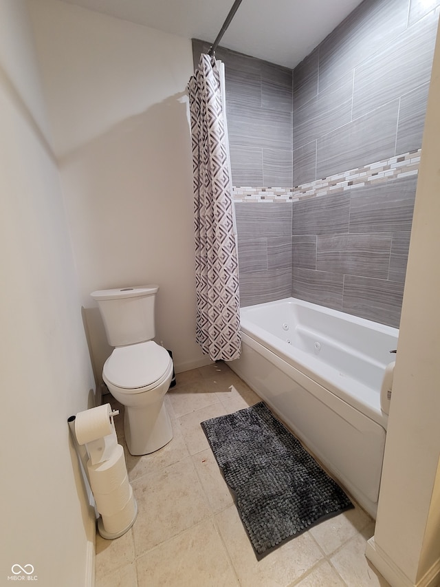 bathroom featuring shower / tub combo with curtain, tile patterned flooring, and toilet