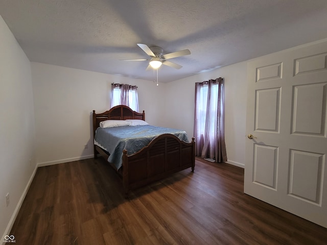 bedroom featuring dark hardwood / wood-style floors, a textured ceiling, and ceiling fan