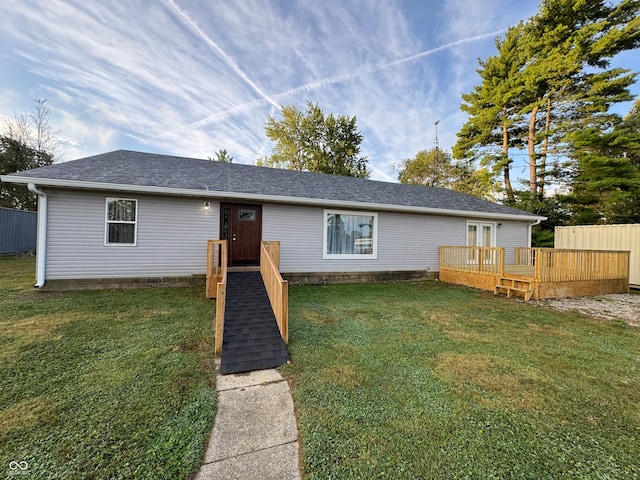 ranch-style home featuring a front yard and a deck