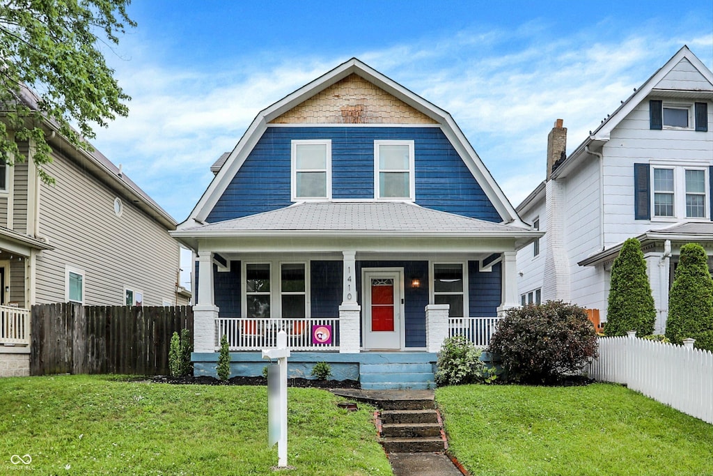 view of front of home with a front lawn and a porch