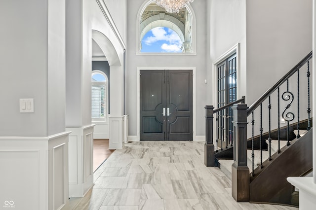 tiled foyer with a high ceiling