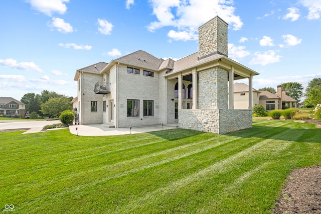 rear view of house with a garage and a lawn