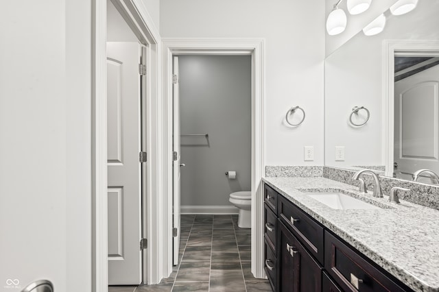 bathroom with tile patterned floors, toilet, and vanity