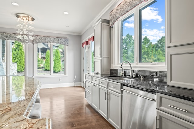 kitchen with sink, dishwasher, light wood-type flooring, and plenty of natural light