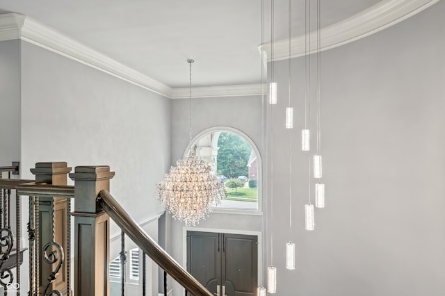 hallway featuring a chandelier and crown molding