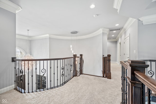 hallway featuring carpet floors, an inviting chandelier, and ornamental molding