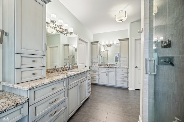 bathroom featuring dual vanity, walk in shower, and tile patterned flooring