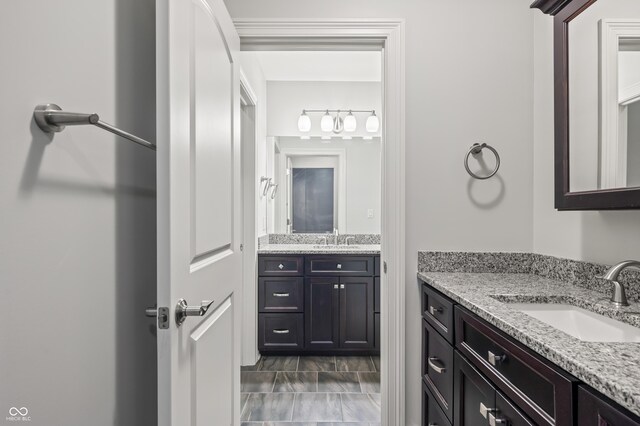 bathroom with dual vanity and tile patterned floors