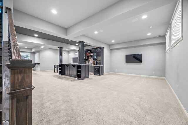 unfurnished living room featuring light colored carpet and bar