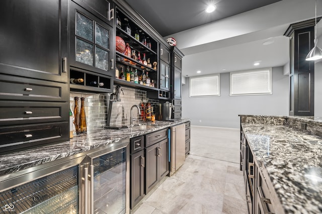 bar featuring dark stone counters, sink, backsplash, light tile patterned floors, and wine cooler