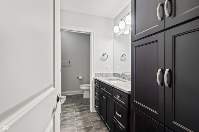 bathroom with vanity, tile patterned flooring, and toilet