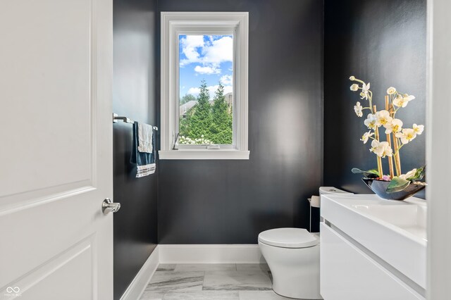 bathroom featuring tile patterned flooring, toilet, and vanity