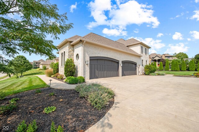 view of side of home featuring a garage and a lawn