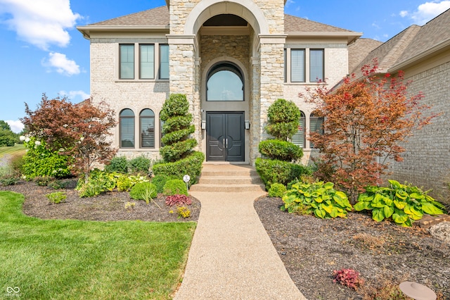 entrance to property with a lawn