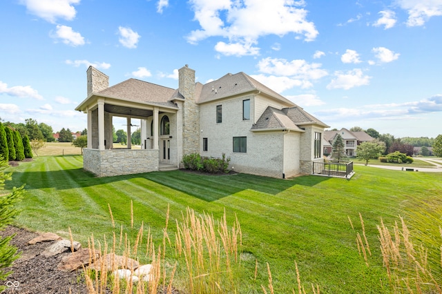 rear view of house with a yard