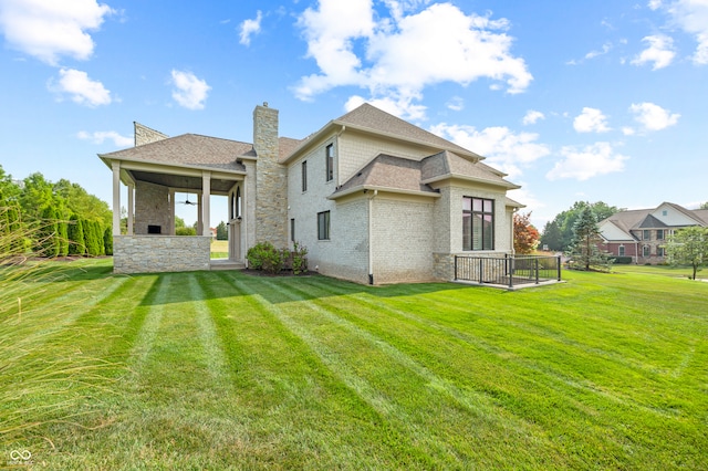 back of house featuring a lawn