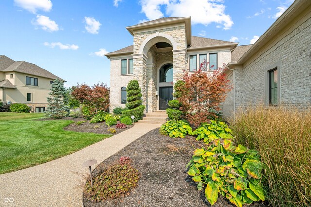 mediterranean / spanish-style home featuring a front yard