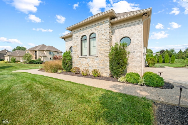 view of home's exterior with a lawn