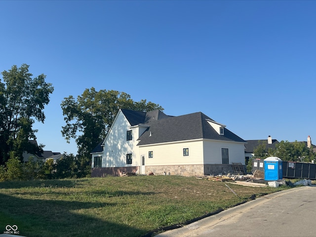 view of home's exterior with a yard