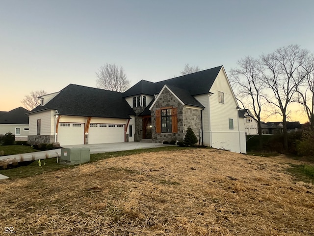 view of front of home with a garage and a lawn