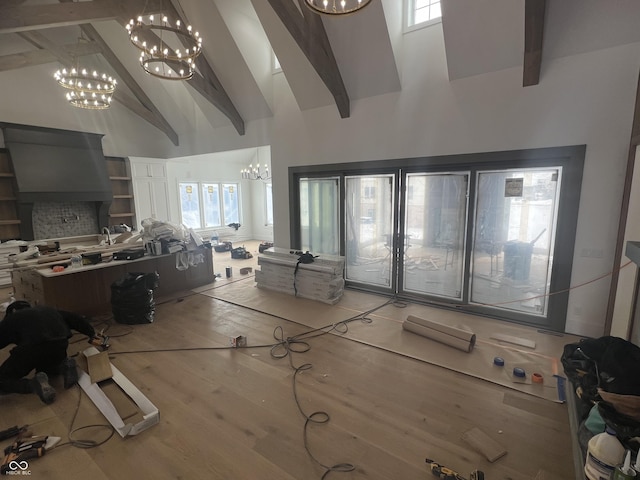 living room featuring beam ceiling, a notable chandelier, hardwood / wood-style flooring, and high vaulted ceiling