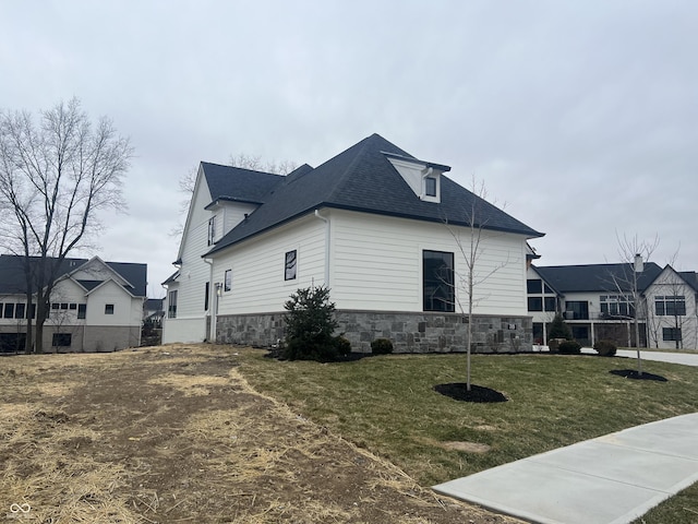 view of side of property with a lawn