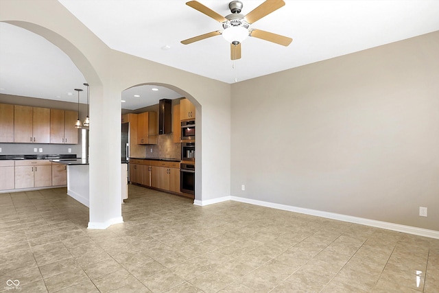 kitchen with oven, ceiling fan, and hanging light fixtures