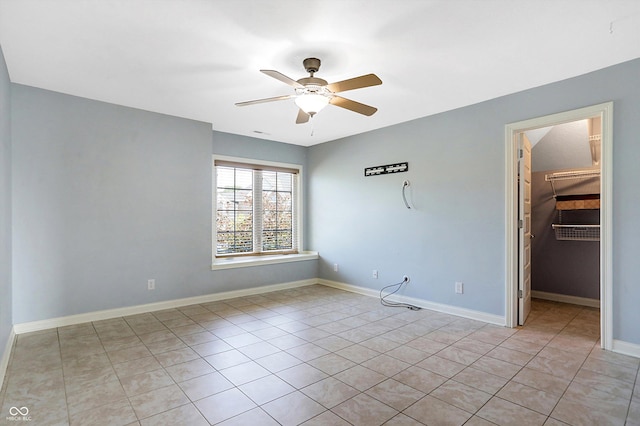 tiled spare room with ceiling fan