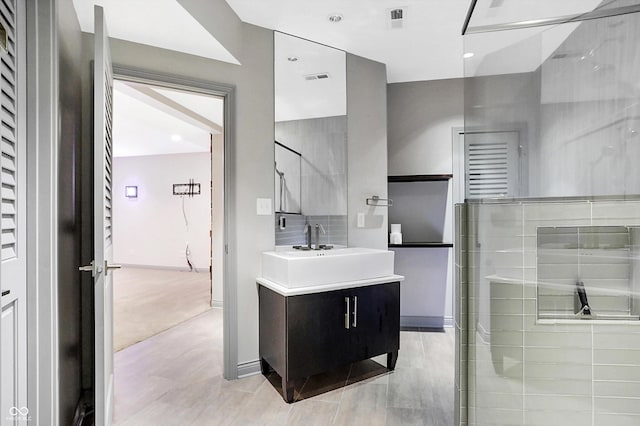 bathroom featuring vanity and a shower with shower door