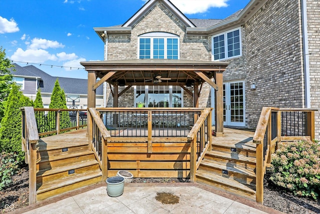 wooden deck featuring a gazebo and ceiling fan