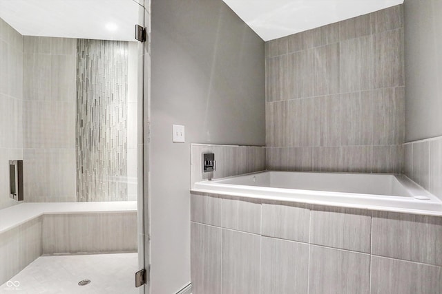 bathroom featuring separate shower and tub