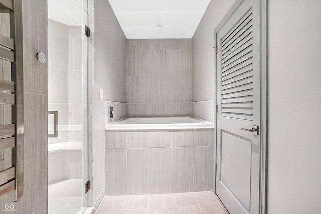 bathroom featuring independent shower and bath and tile patterned flooring