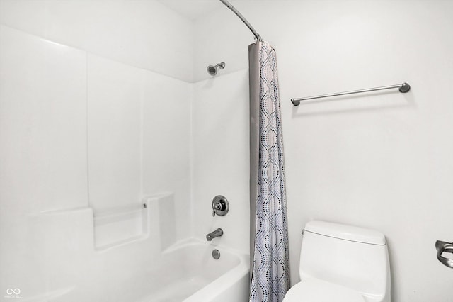 bathroom with shower / bath combination with curtain and toilet