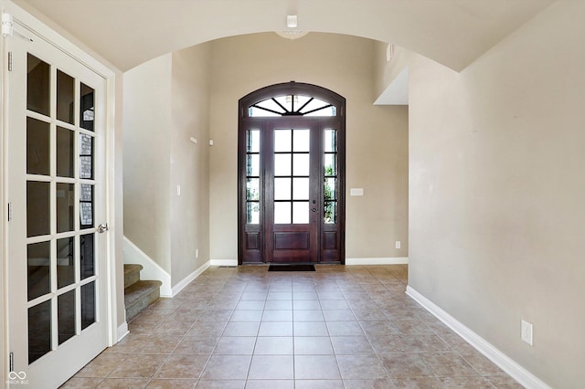 tiled entrance foyer with lofted ceiling