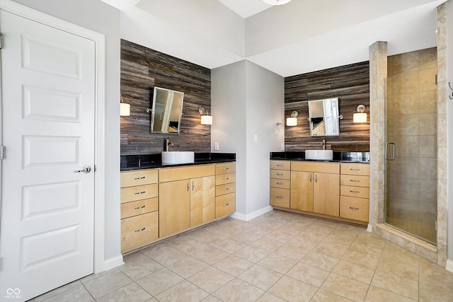 bathroom featuring vanity, tile patterned flooring, wooden walls, and a shower with shower door