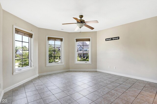 unfurnished room featuring ceiling fan and light tile patterned flooring