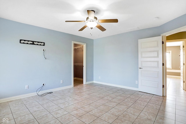 unfurnished room with ceiling fan and light tile patterned floors