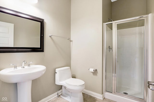 bathroom with toilet, a shower with shower door, tile patterned floors, and sink