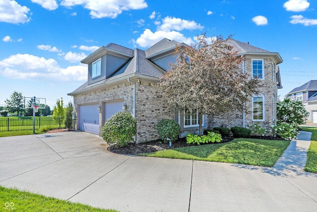 view of front of property featuring a front yard and a garage